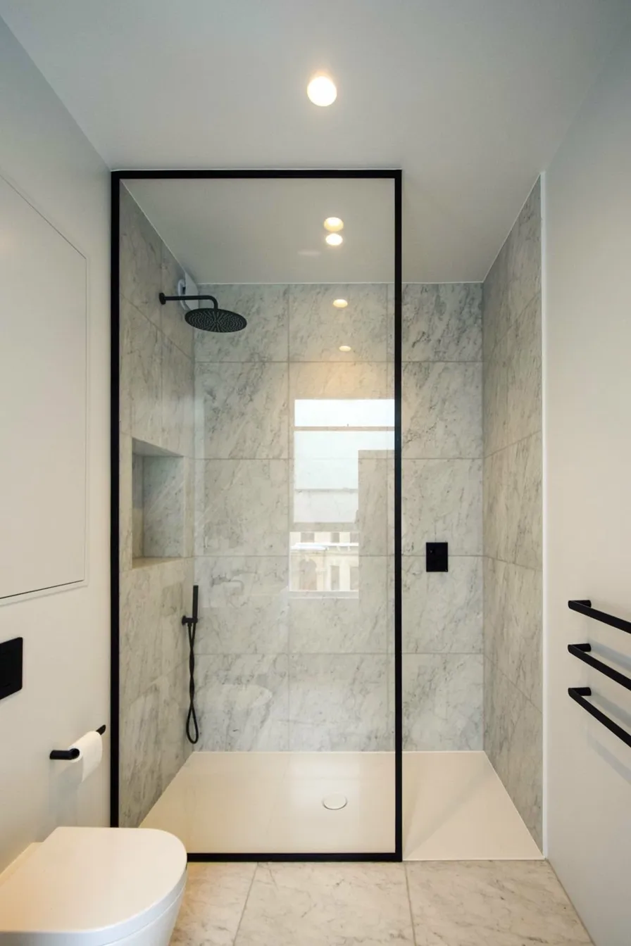 Frameless shower enclosure